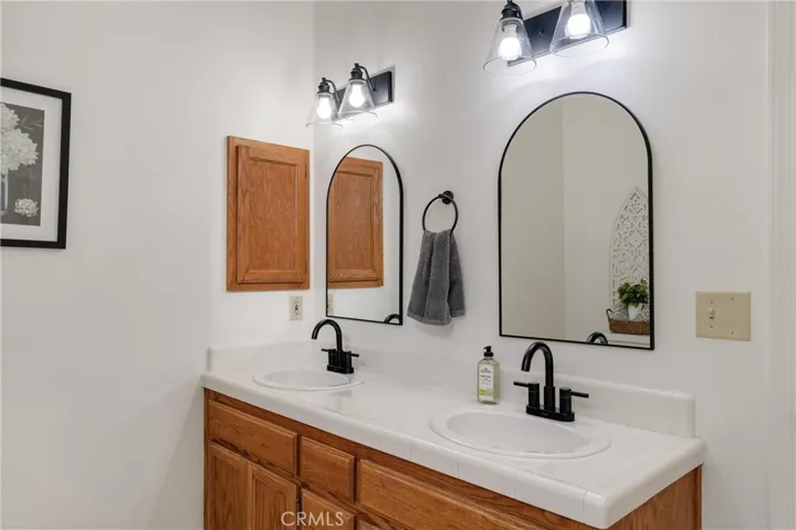 Double vanity in hall bathroom. New faucets, lights and mirrors.