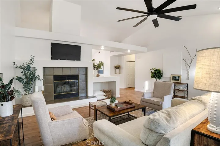 Open, large living room with fireplace. Brand new ceiling fan.