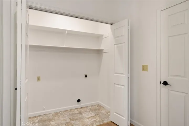 Laundry closet in between the primary bedroom and the garage entrance