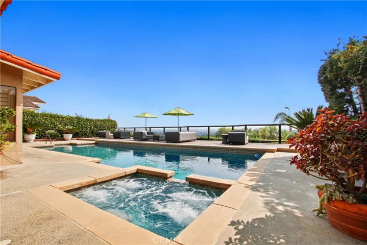 Pool  and relaxing jacuzzie in stunning ocean view yard.