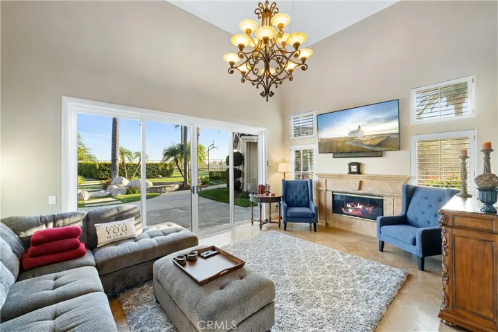 Formal living room view through the 16' French sliding door and fireplace.