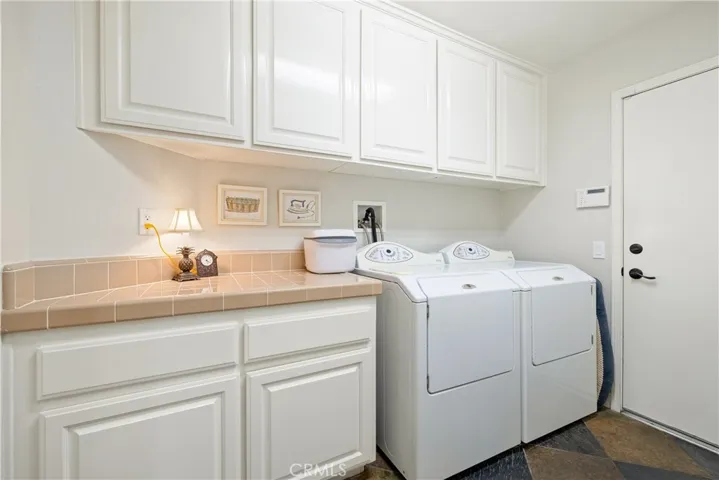 Laundry room with storage, the door leads to the three car garage.