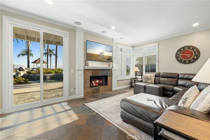 Family room view through sliding door with fireplace in view.