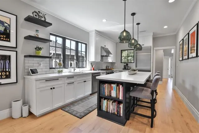 Slab counters with suede finish. Extended island top with lots of legroom. Soft-close drawers