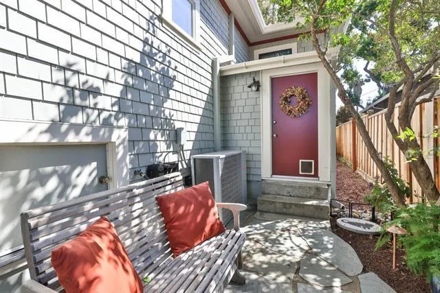 Additional under-house storage (shown behind the bench) and side, exterior entrance to the basement.