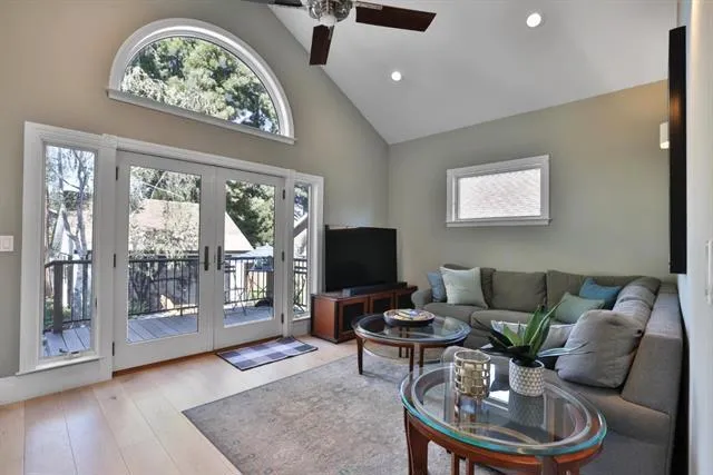 Layout 1 as a family room. Soaring, vaulted ceiling, dramatic glass doors and huge half round window