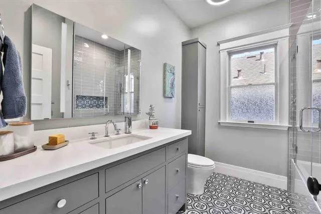 Toto toilet; designer tile; lighted mirror/cabinet; lights w/ speaker system; custom corner cabinet