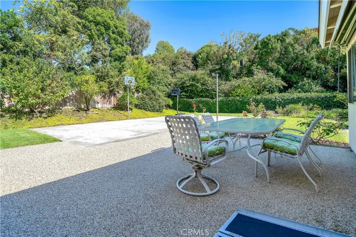 Backyard patio with 2 basketball poles.