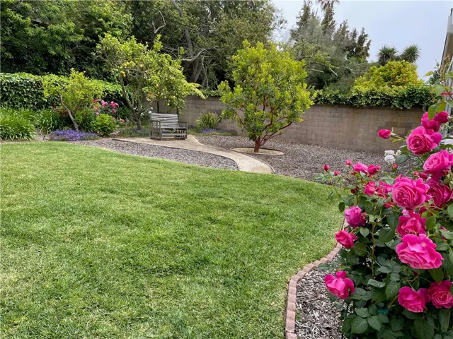 Another view of the beautiful backyard with the bench for having a peaceful moment