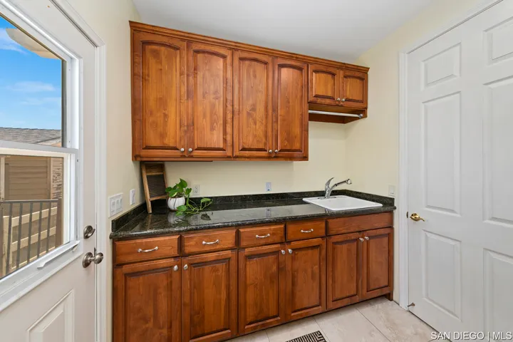Spacious laundry room has tons of storage!