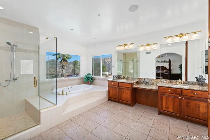 Hall bathroom has double sinks and jacuzzi tub/shower.
