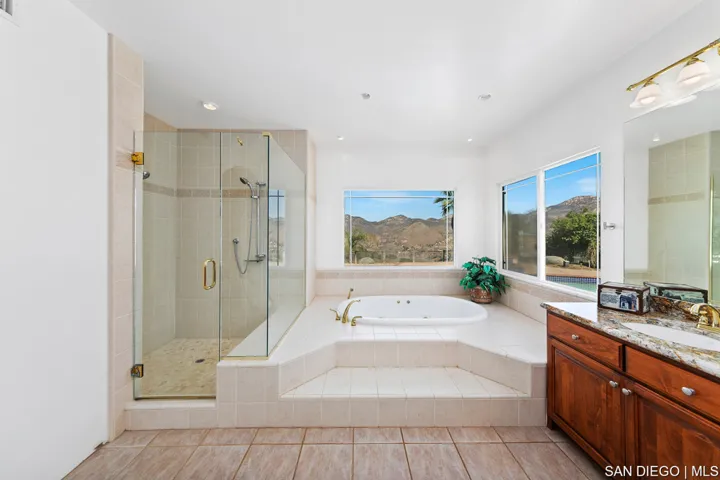 Hall bathroom has double sinks and jacuzzi tub/shower.