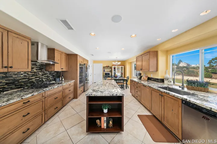 Kitchen was fully remodeled in 2020 to include center island, granite countertops, and custom cabine