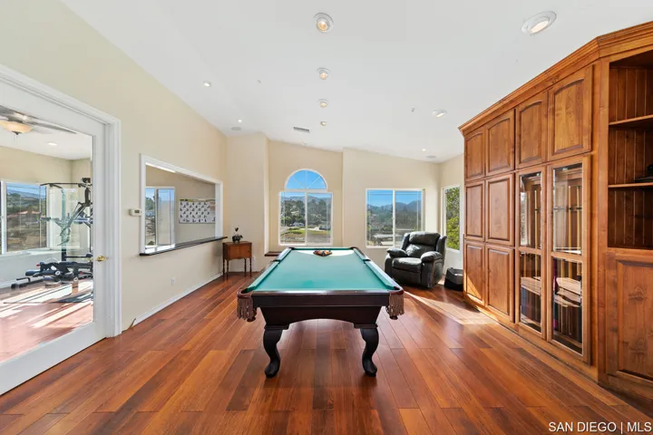 Tri-level layout - upper great room has area for Billiard table with built-ins, gas fireplace, and e