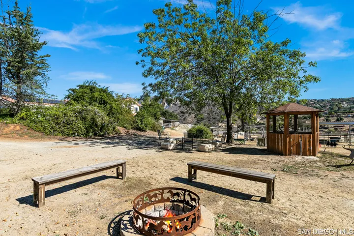 view from horse riding arena toward Horse stalls and Casita