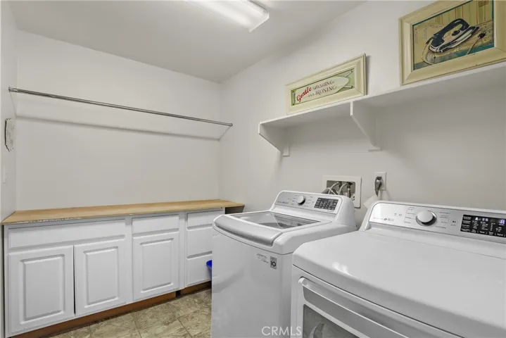 Laundry room with shelving and cabinetry.