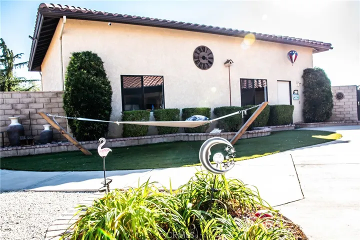 Rear yard with low maintenance landscaping, block wall, hammock, RV garage/workshop