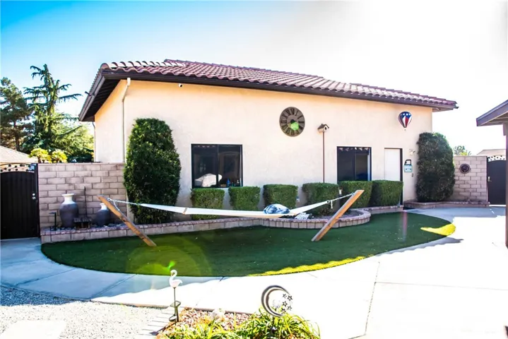 Rear yard with low maintenance landscaping, block wall, hammock, RV garage/workshop
