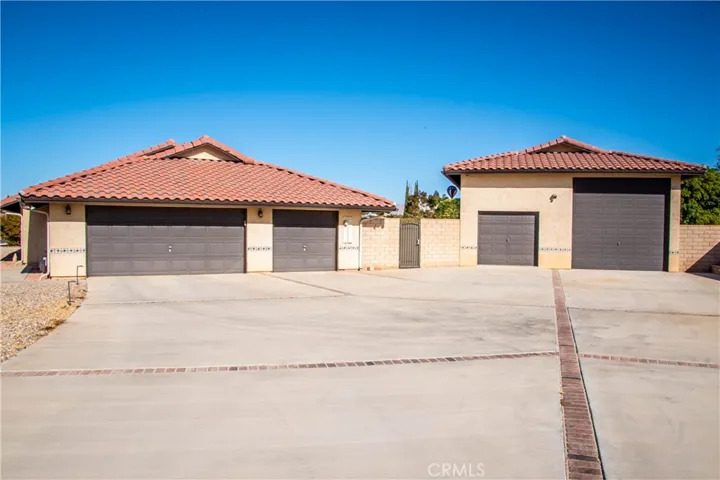 Front of home showing RV garage, toy garage, 3 car attached garage, and tons of room for parking