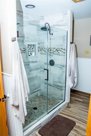 Master/primary bedroom Shower.  Bathroom also includes dual vanities, custom tile backsplash, wood grain tile floors, free standing tub and separate shower.
