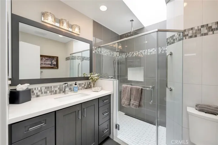 Bathroom #2 is FULLY Remodeled with Large Walk-in Shower, with Glass Surround, Vanity with Quartz Countertop, and Skylight!