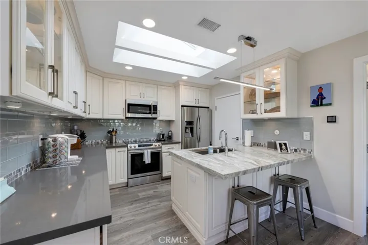 LED Recessed Lighting, Glass Tile Back Splash, Large Stainless Sink, and Direct Garage Access