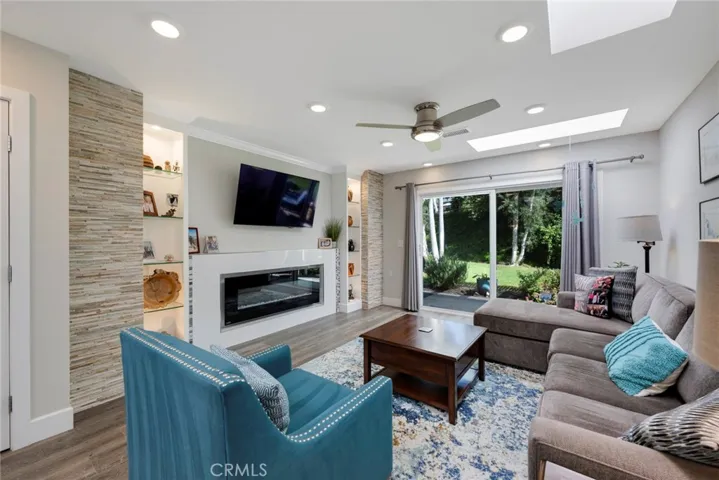 Fireplace, Built-in Shelving, Custom Stacked Stone Detail, Ceiling Fan/Light, and Neutral Tone Paint throughout!