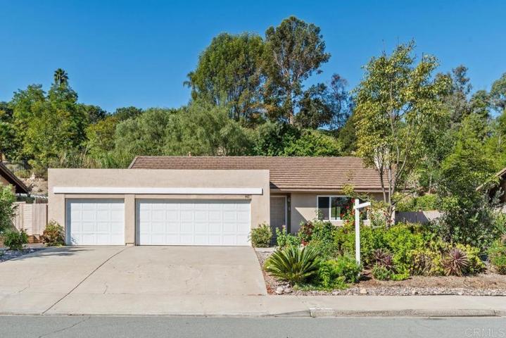 3 car garage with workbench, laundry and storage shelves.