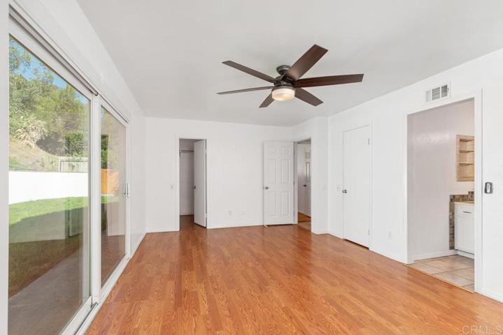 Large primary bedroom with sliding door access to the backyard.