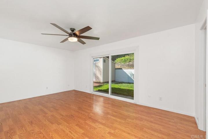 Large primary bedroom with sliding door access to the backyard.