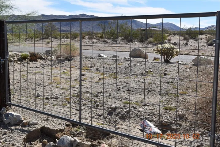 RV gate on adjacent   lot being sold WITH the house NOT as separate parcel
