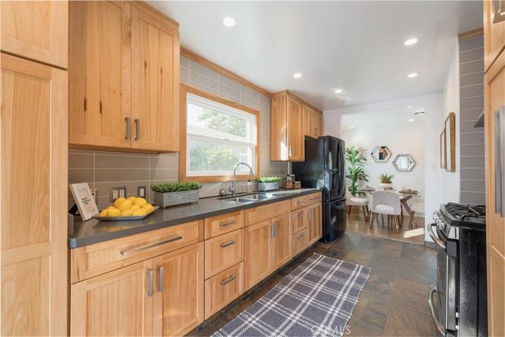 Custom tile backsplash, fossil slate flooring & recessed lighting.
