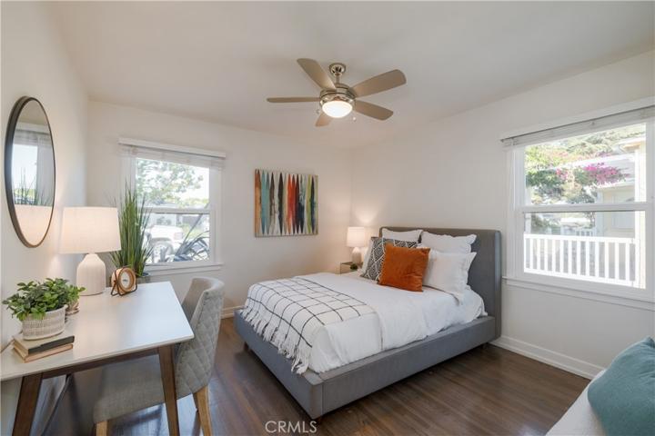 Bedroom 1 features hardwood flooring & Milgard windows.
