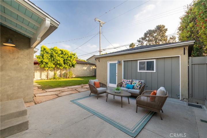 Long driveway takes you to a patio area and backyard.