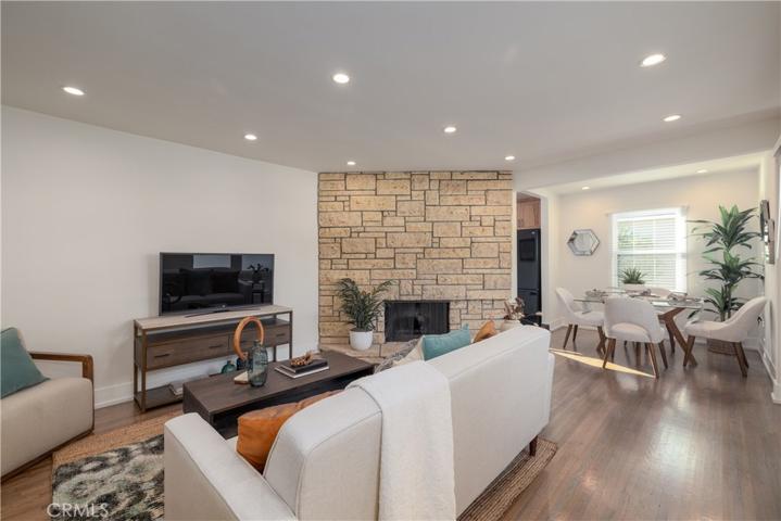 Living room features recessed lighting & wood flooring...