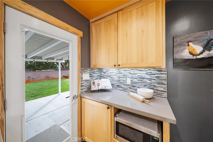More cabinets with pull out trash and recycle bins