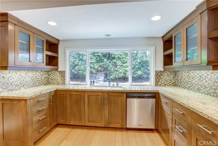 Custom cabinetry, granite countertops, stainless appliances, recessed lighting.