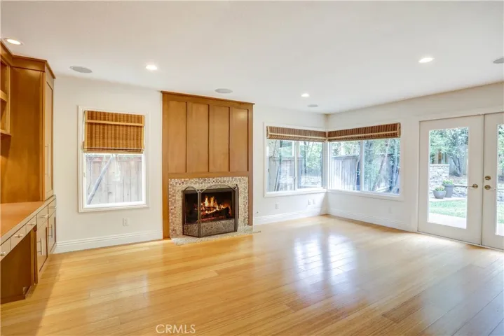 Family room with gas fireplace, custom built ins, recessed lighting and french doors leading to the backyard.