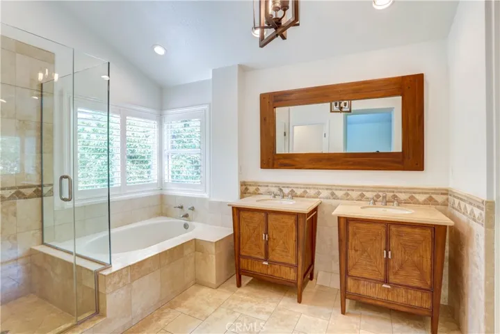Fully renovated master bathroom with step in shower, soaking tub and dual vanities.