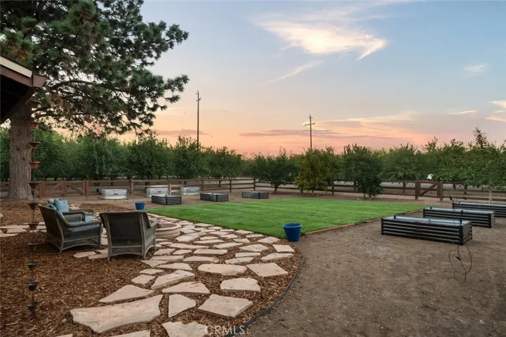Front Yard with sunset views, firepit and garden beds.