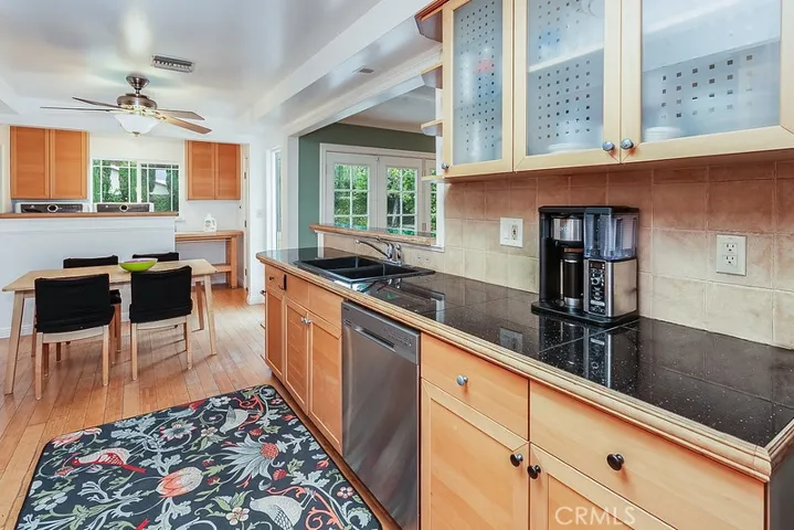 The cook in the family is going to truly appreciate the spacious kitchen with its sparkling window, lighted ceiling fan, chic modern cabinetry with frosted glass inserts, granite tile countertops, tiled backsplash, dual basin sink, state-of-the-art Samsung stainless steel appliances which include a 5-burner gas range and dishwasher, range hood, stunning bamboo floors and a handy breakfast nook.