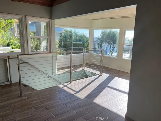 Ocean view living space with a stairway downstairs.