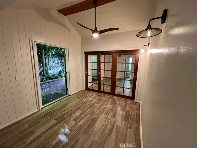 A main floor secondary bedroom with a mirrored triple closet.