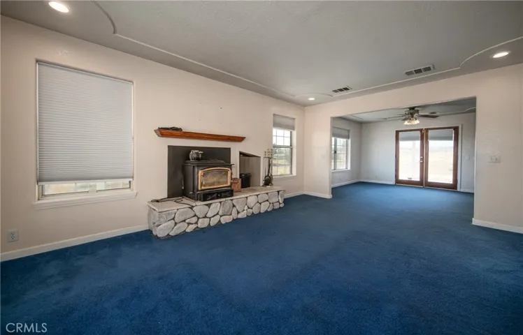Living room with fireplace and wood storage