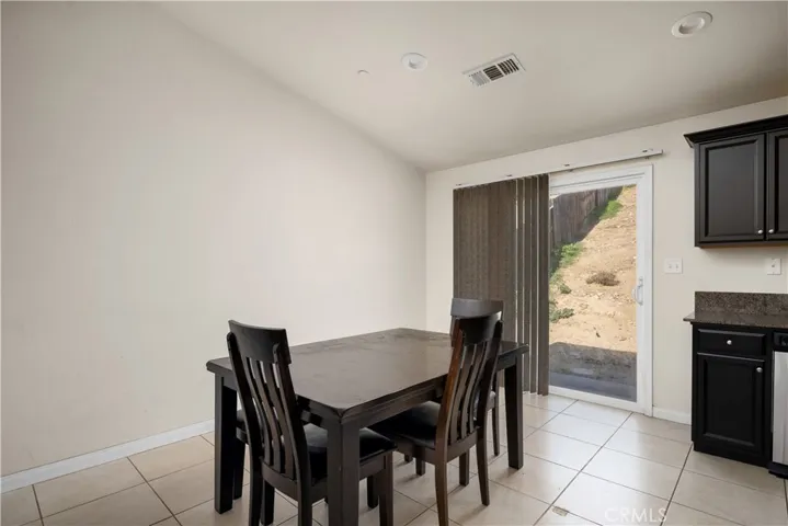 Dining area by sliding doors to backyard.