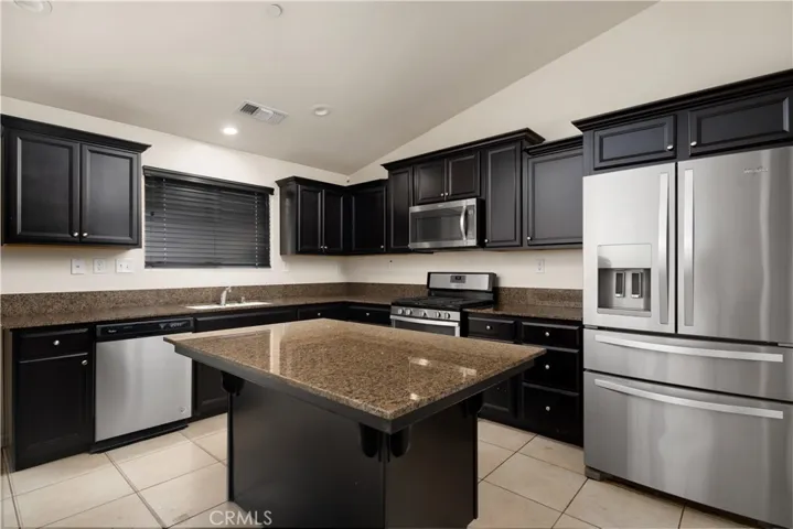 Nice cabinets and island. Walk-in Pantry to the right of refrigerator.