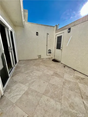 patio between home and garage with outdoor shower