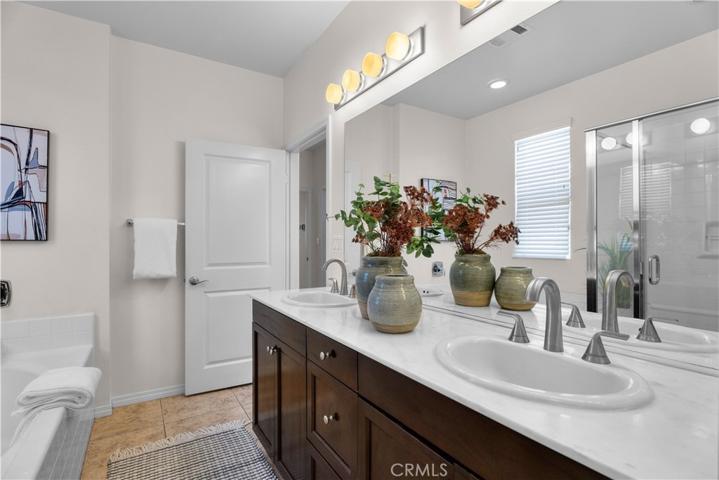En-suite primary bathroom with dual sinks, separate tub and shower.