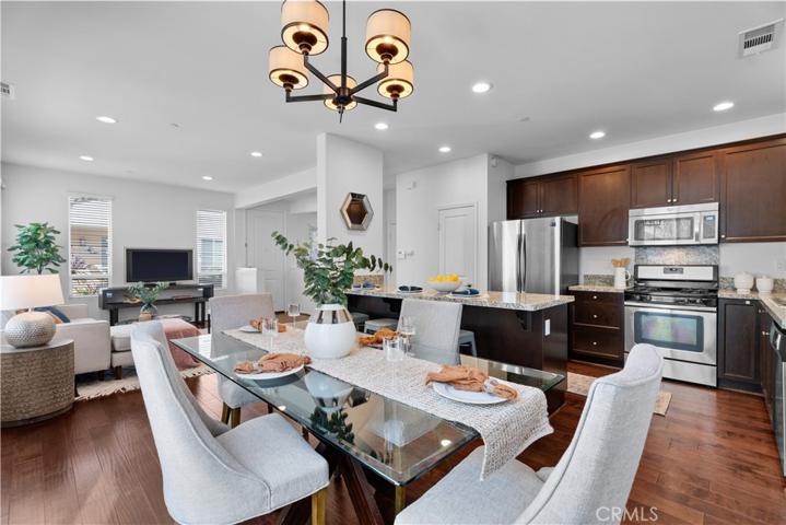 Spacious open floor plan with tons of light, engineered hardwood floors, granite countertops, recessed lights.