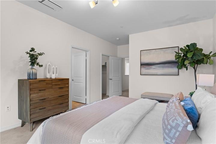Primary bedroom with dual walk-in closets and en-suite primary bathroom.